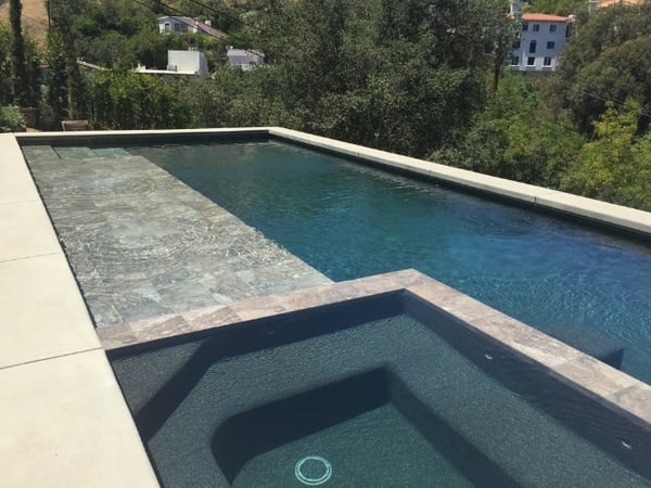 rectilinear pool with a wet solarium platform or baja step for tanning
