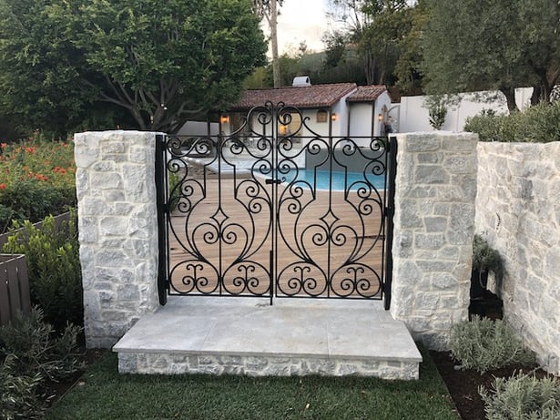 black iron gate with latch and lock protecting pool perimeter