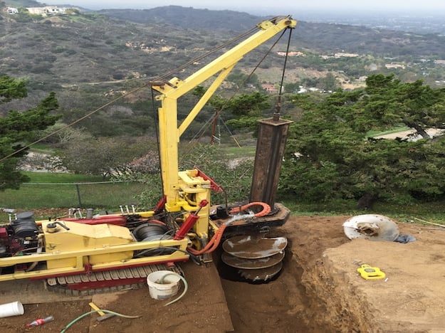 crane hitting bedrock on hillside