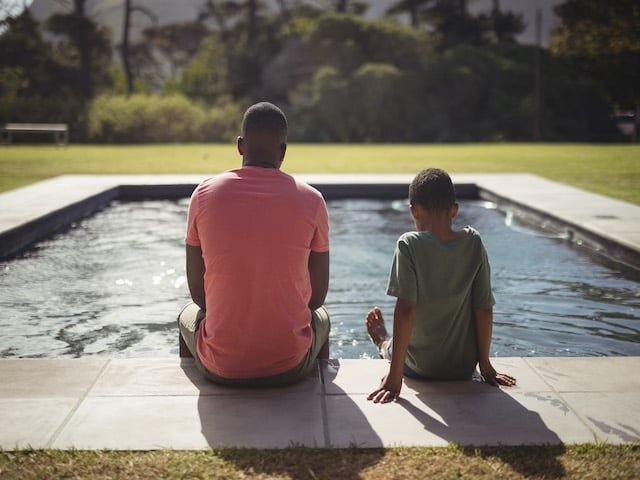 Blue Mind Visual Aid with father and son sitting by edge of swimming pool