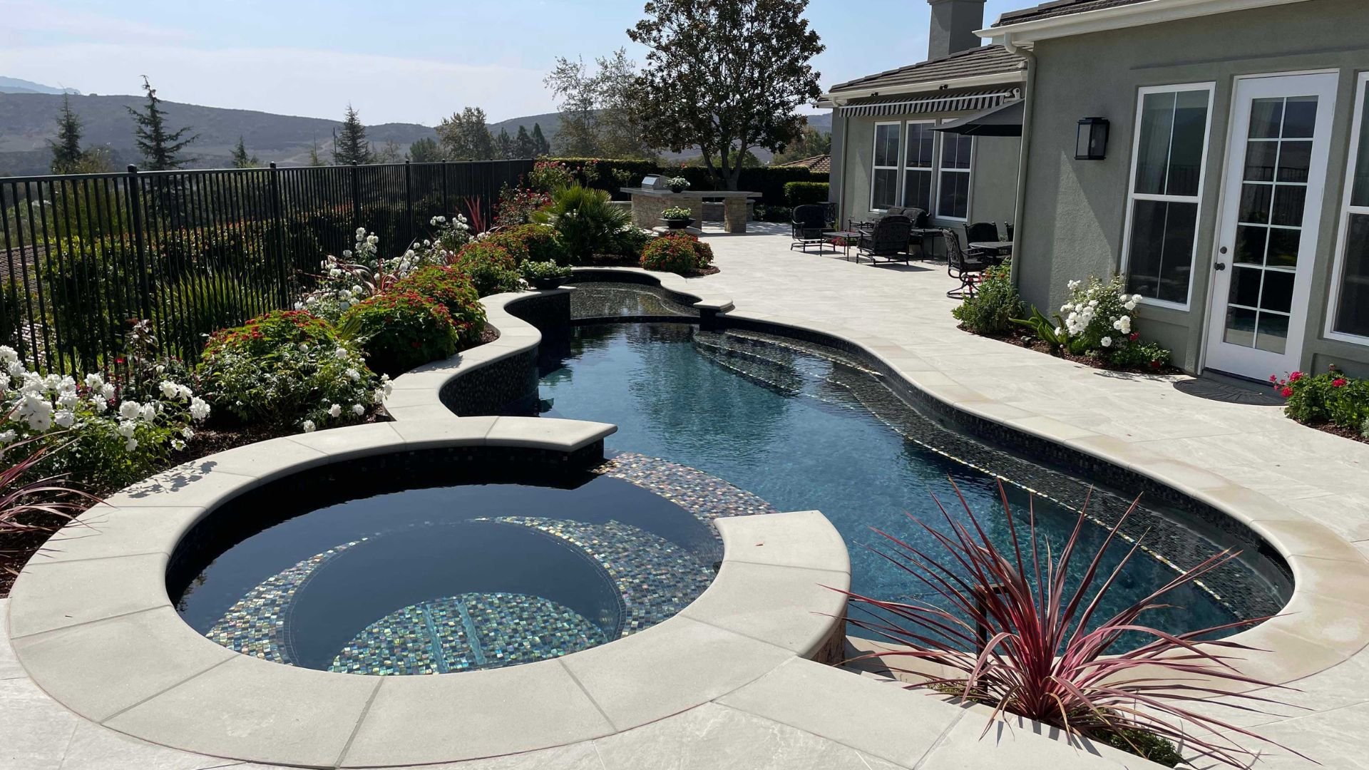 free form pool and spa with glass tile