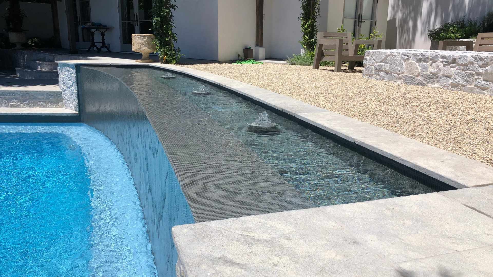 Poolside water features fountains and stone detailing