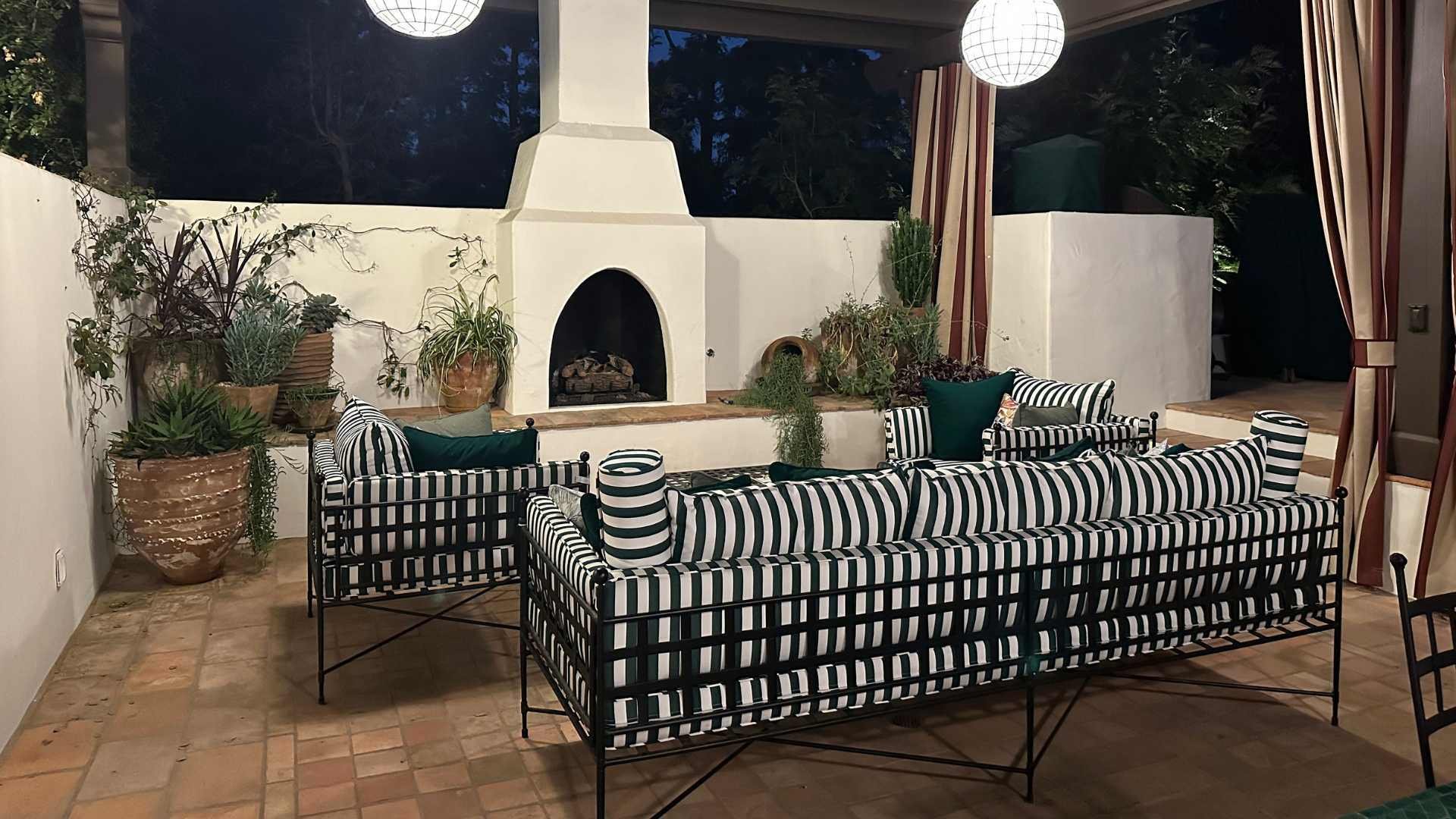 view of an outdoor living room with a fireplace