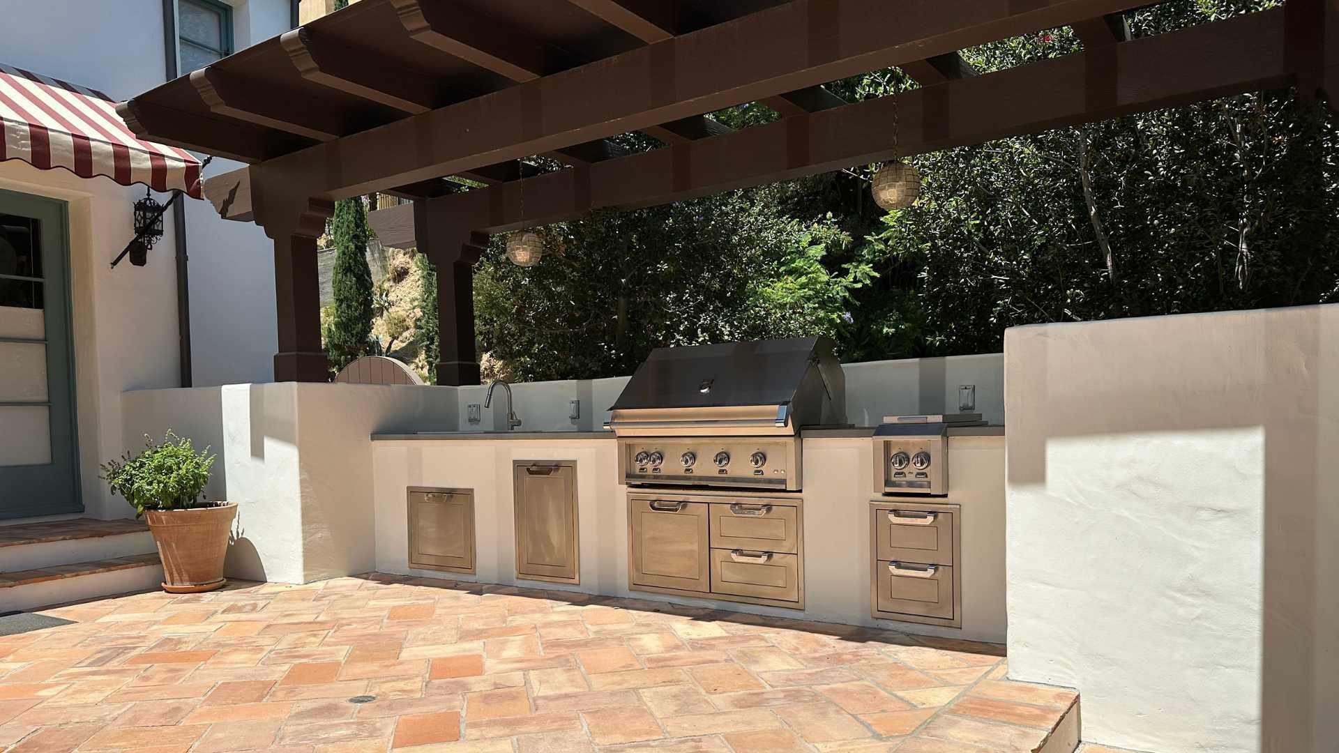 View of a custom-made BBQ under a patio cover.