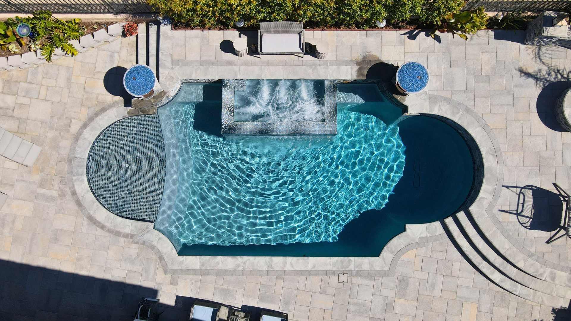 an aerial view of a classic Roman pool and patio area