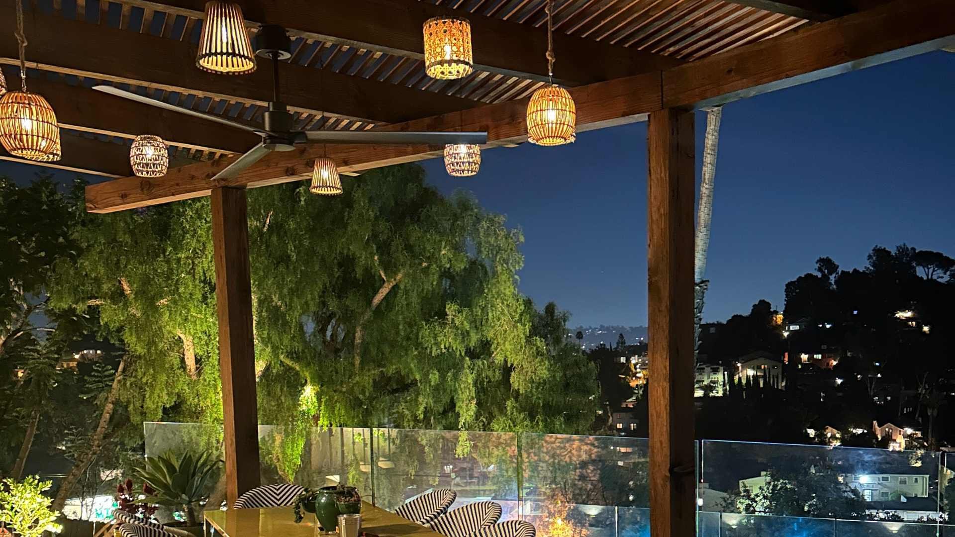 night view of an outdoor dining room with a city view