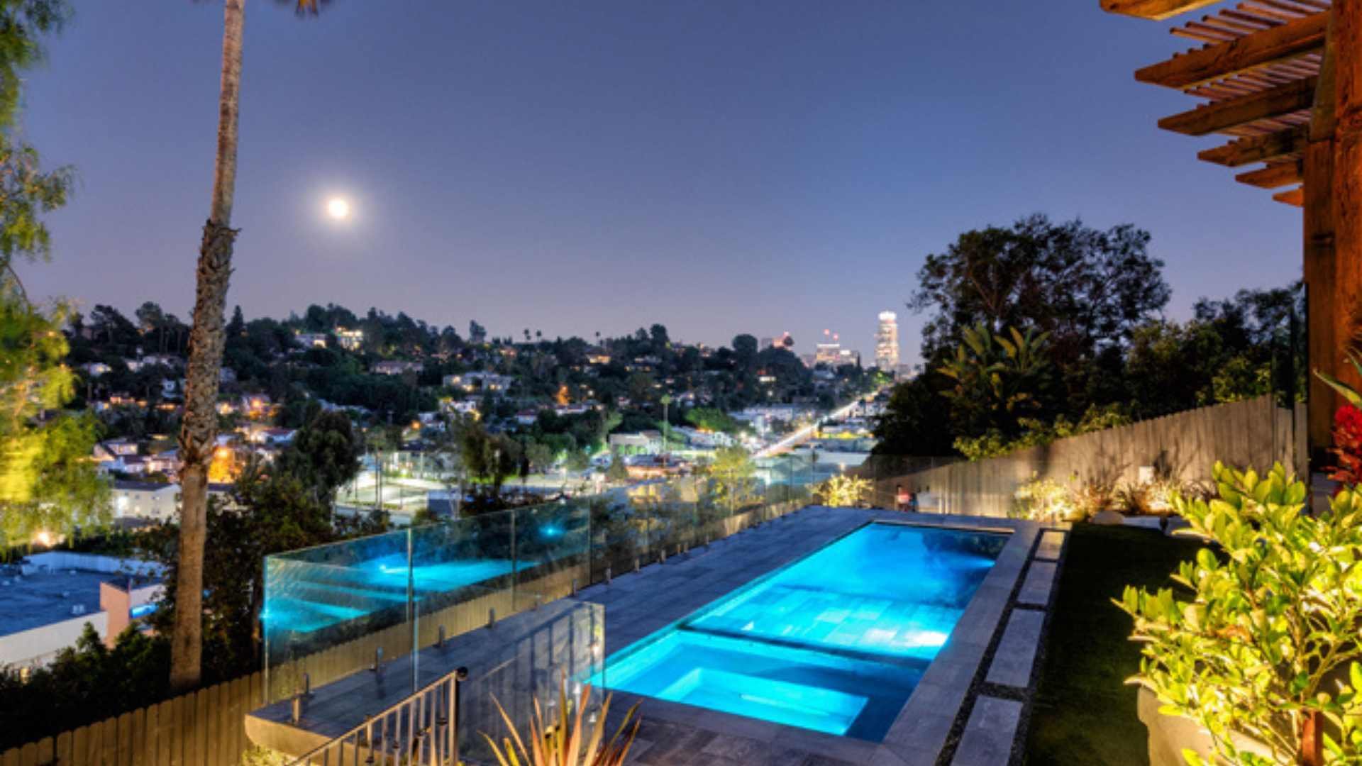 Night view of the modern pool and pergola in Silver Lake, featuring stunning cityscape views and accent lighting.
