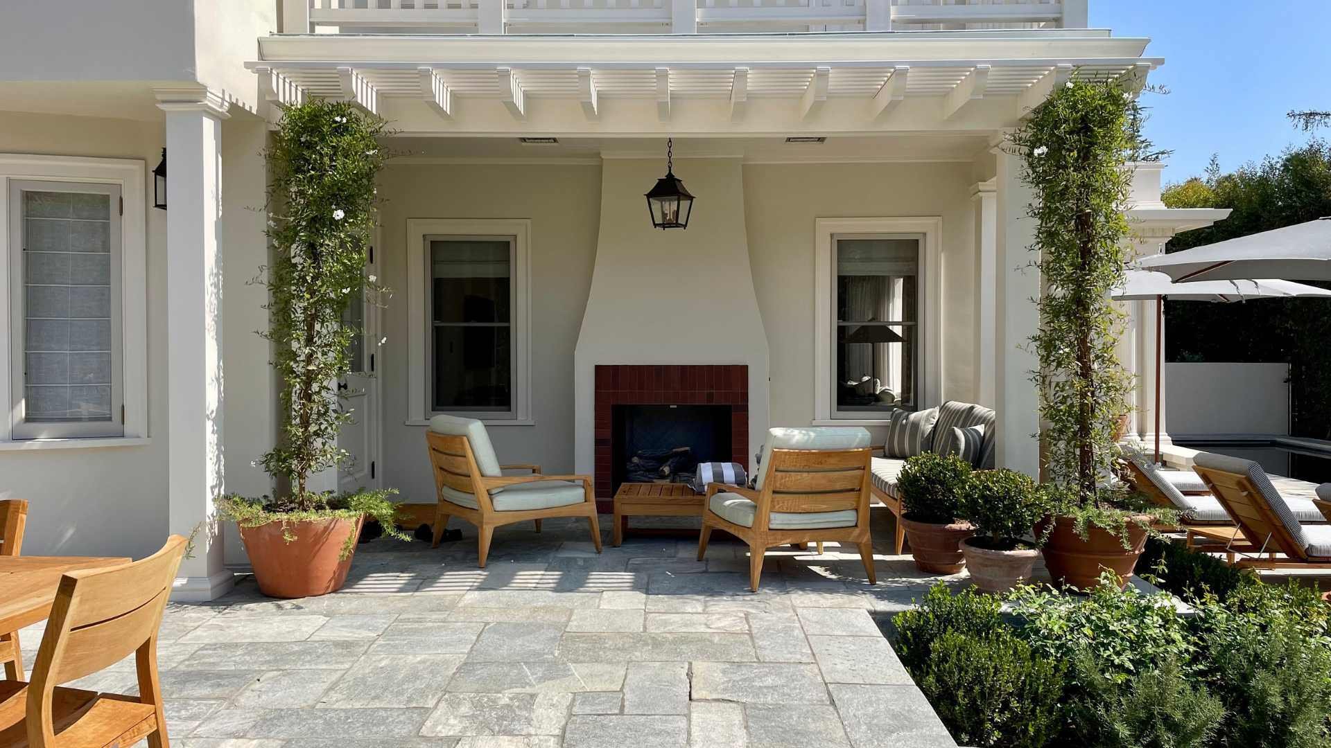 an outdoor fireplace under a patio cover