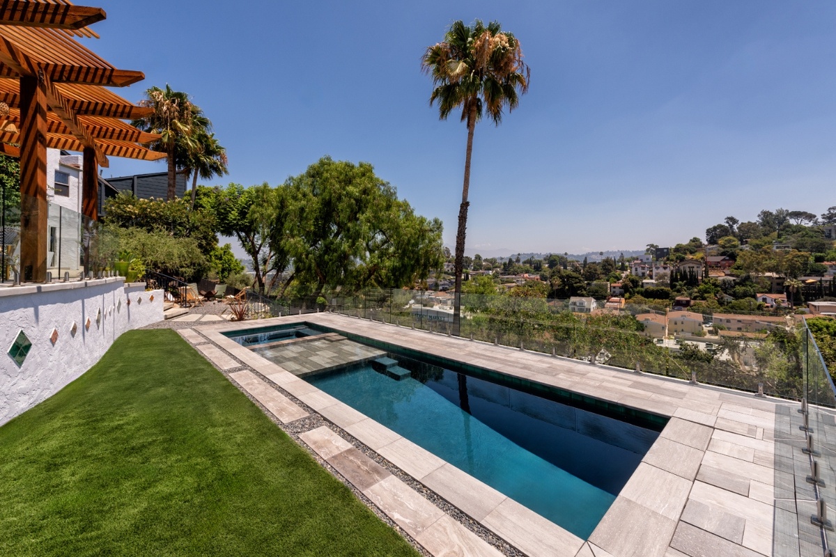 Luxurious pool with Greek marble coping and glass railing, offering a breathtaking view of Silver Lake