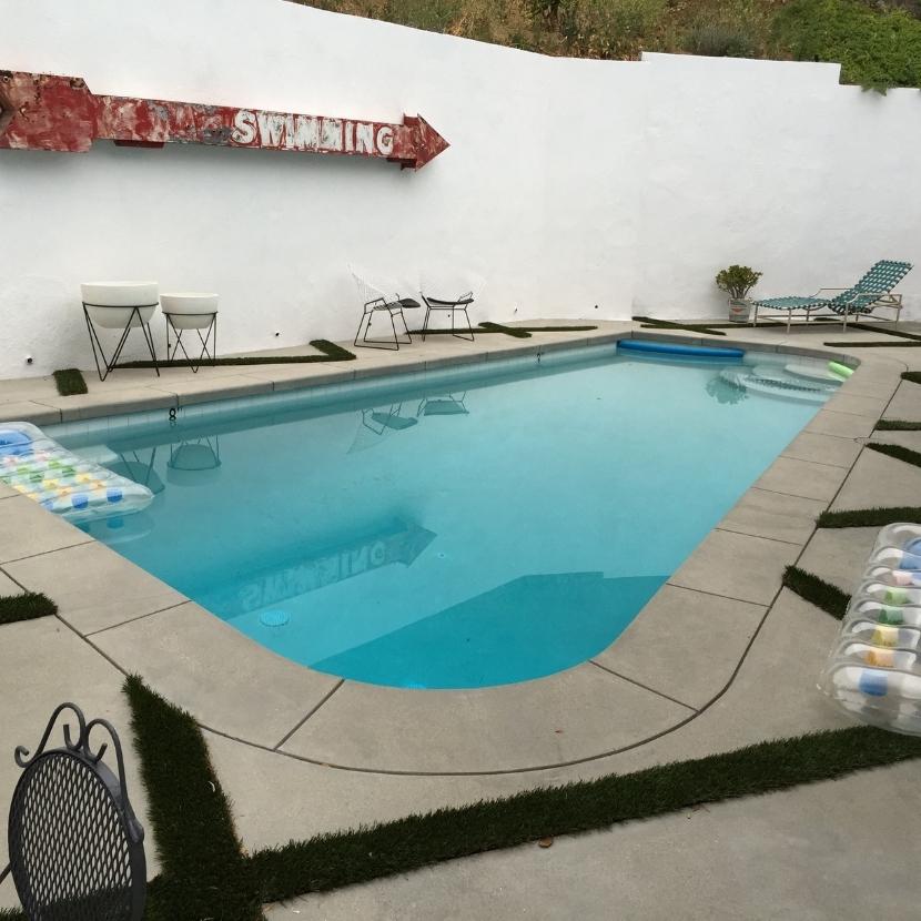 View of a swimming pool with pour-in-place coping and concrete deck