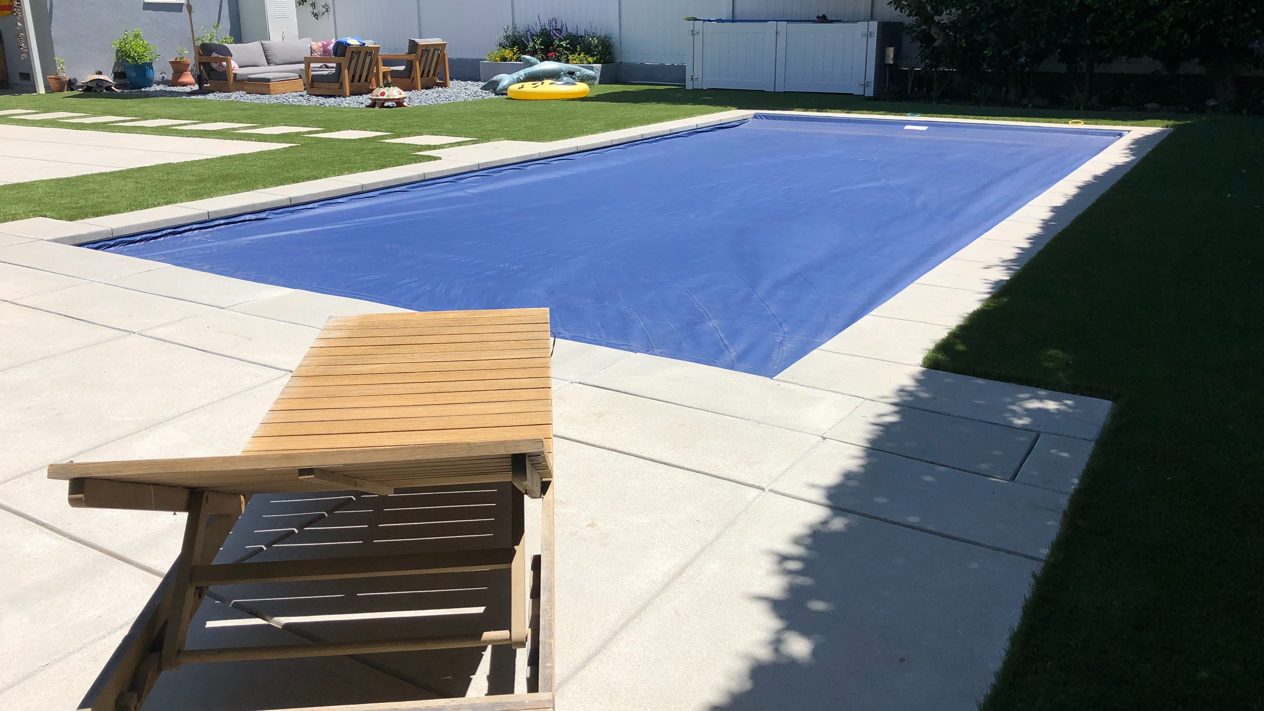 blue automatic cover on backyard pool