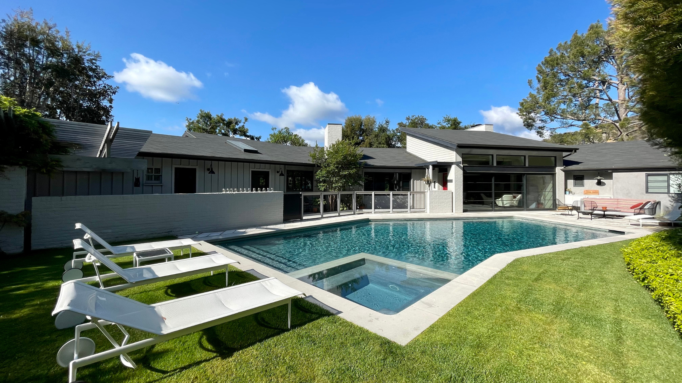 backyard with freeform pool and chaise lounges