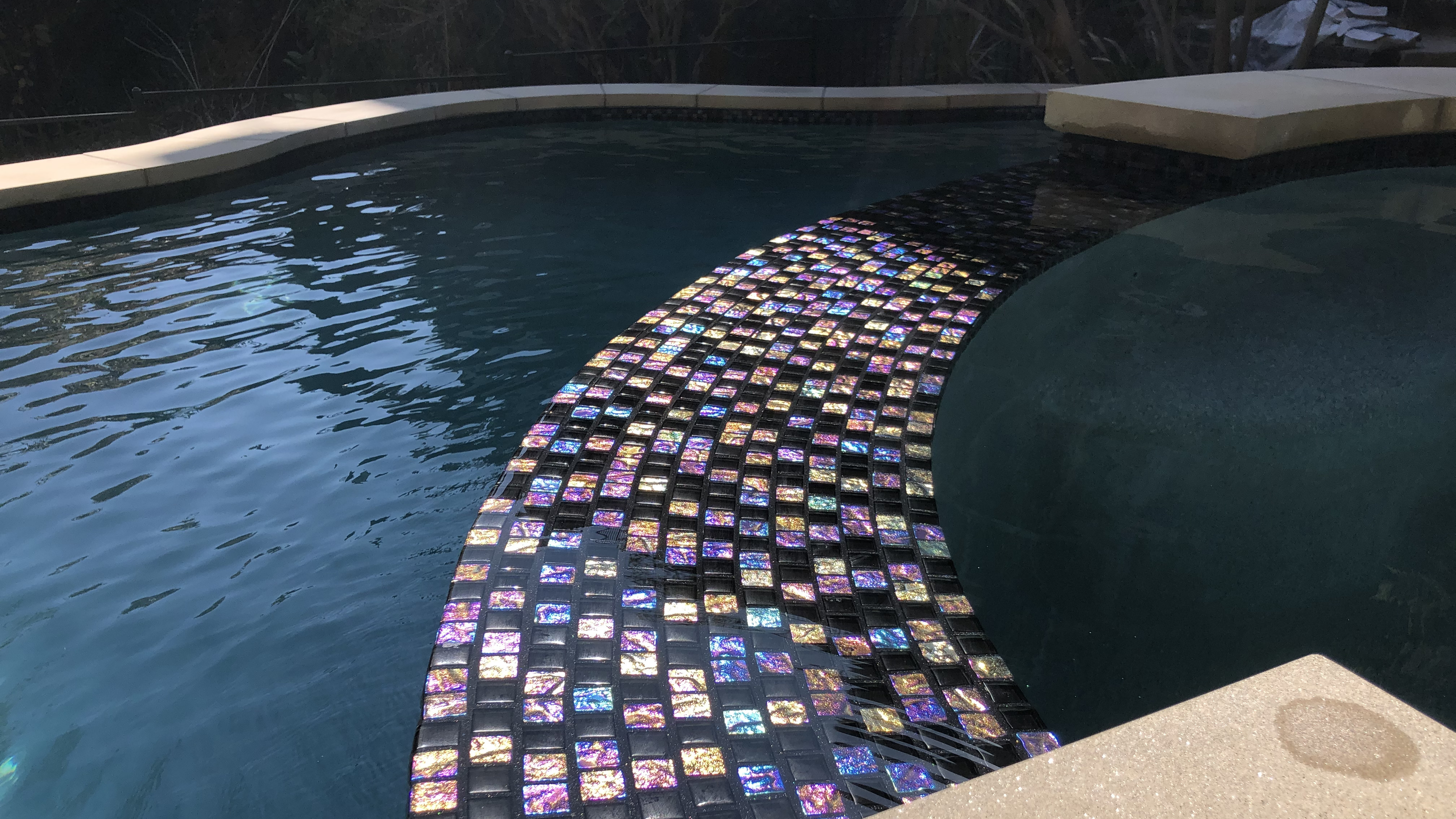 Epoxy grout and glass tile on spillover pool