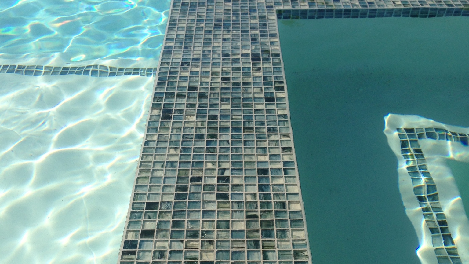 Custom glass tile spillway spa